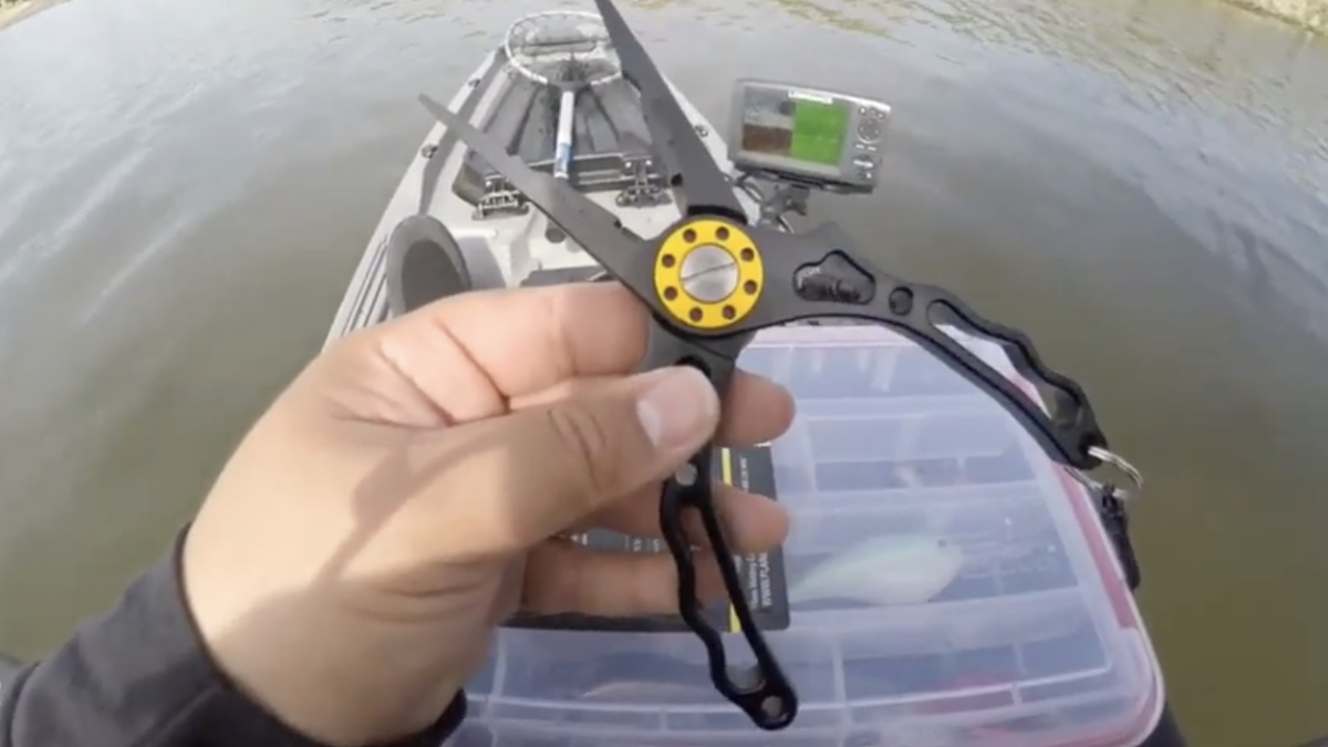 Angler holding Zacx fishing pliers