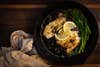 Seared crappie fillets in a cast iron skillet with lemon and capers