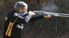 Pro shooter Kay Miculek fires a shotgun on the shooting range.