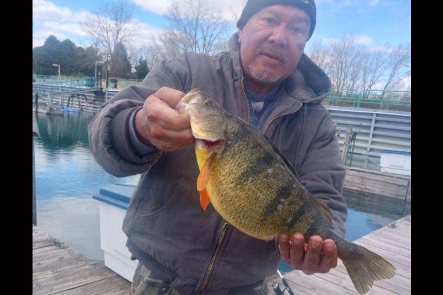 An angler poses with a state-record perch.