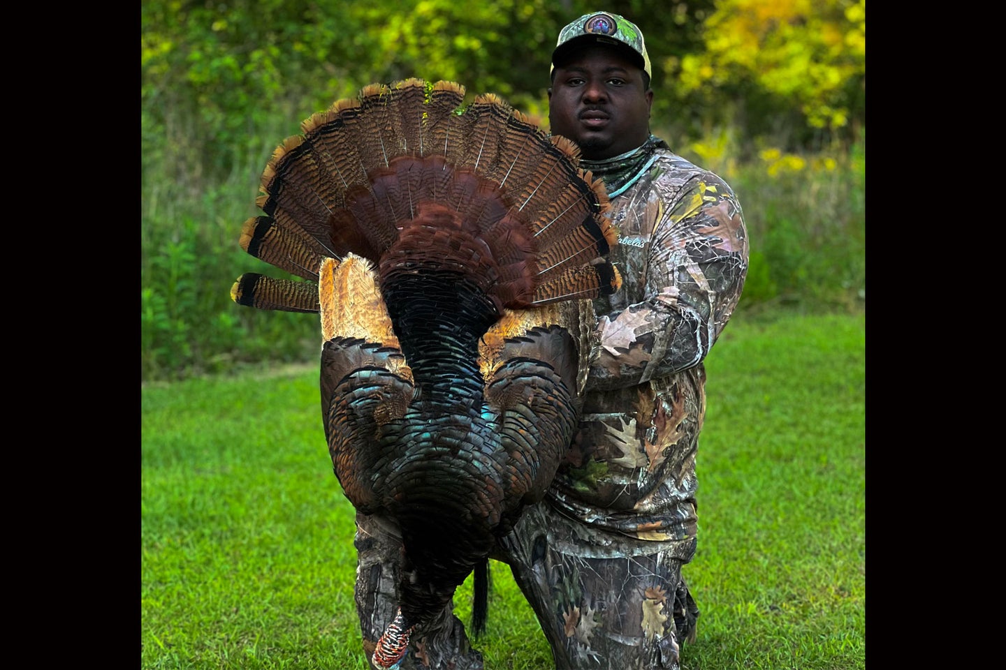 A hunter poses with a rare cinnamon-phase turkey.
